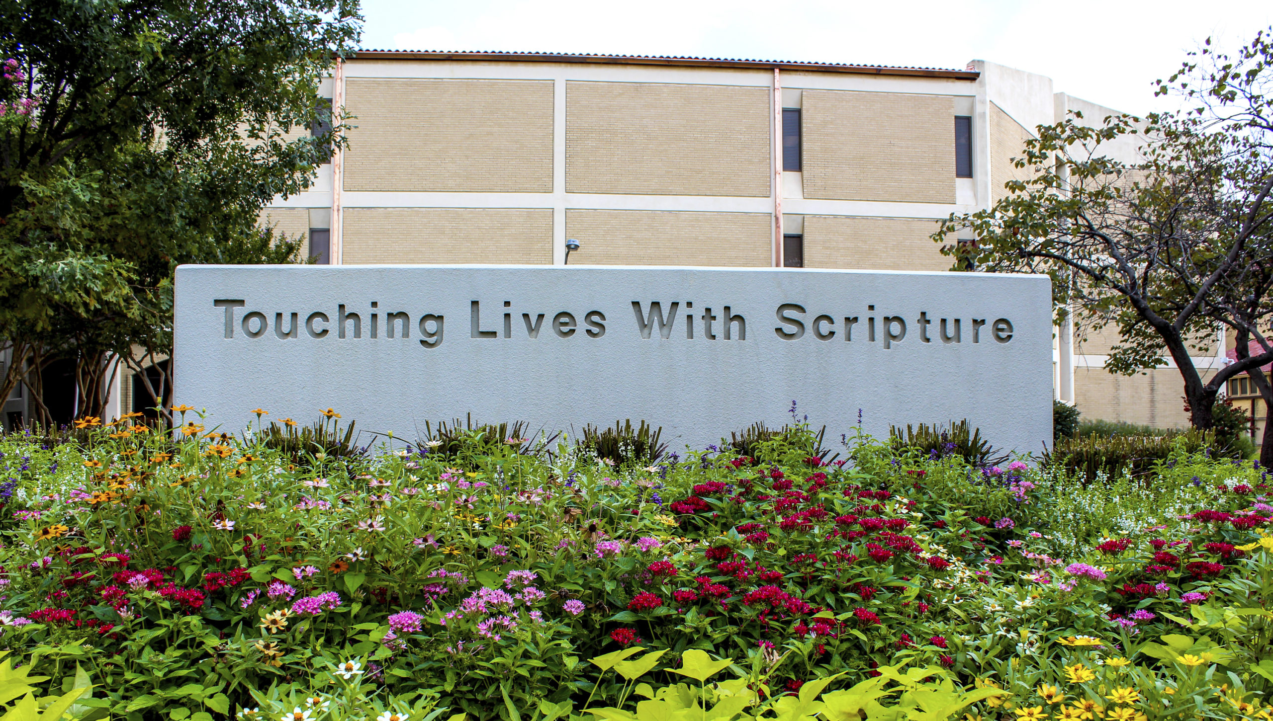 campus sign that reads touching lives with scripture